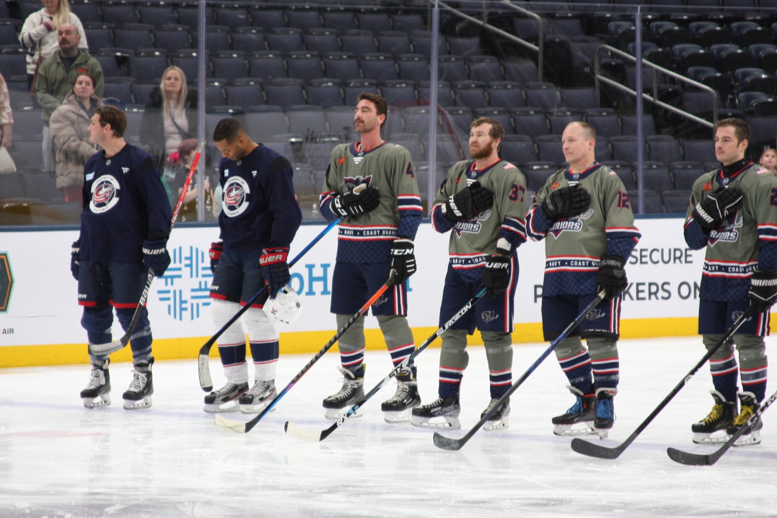 Columbus Warriors players standing along the blue line before a game.