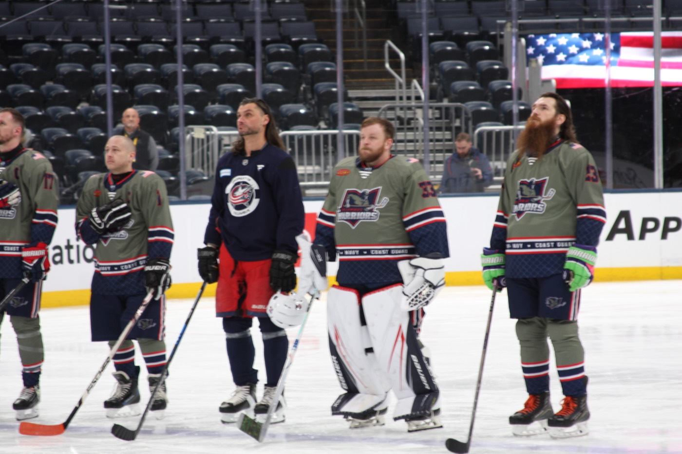 Columbus Warriors players standing together on the ice before a game.